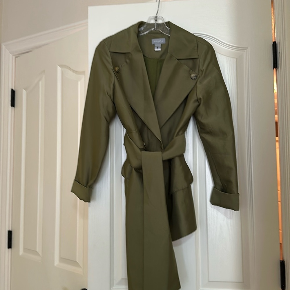 Two piece suit. Jacket has belt/tie closure. Skirt button down front